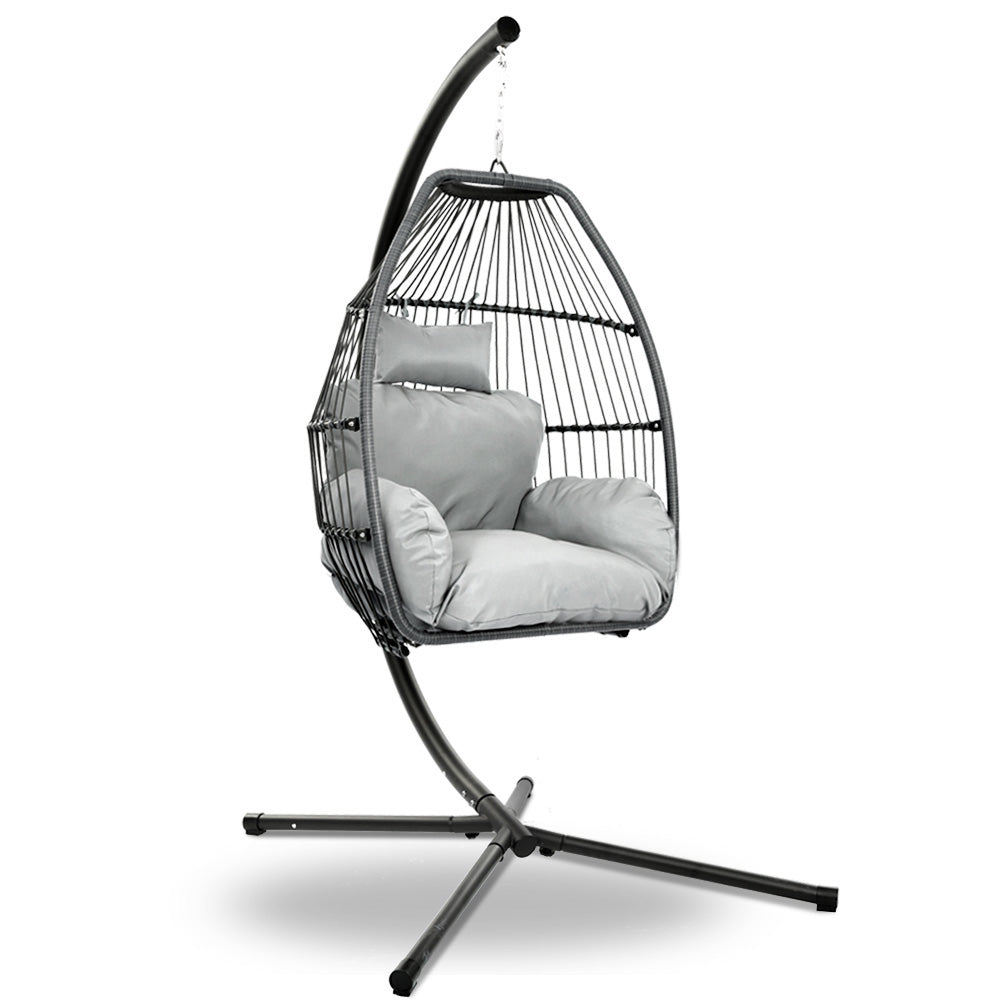 Sussex Inlet grey hand woven wicker hanging egg chair with stand on a patio