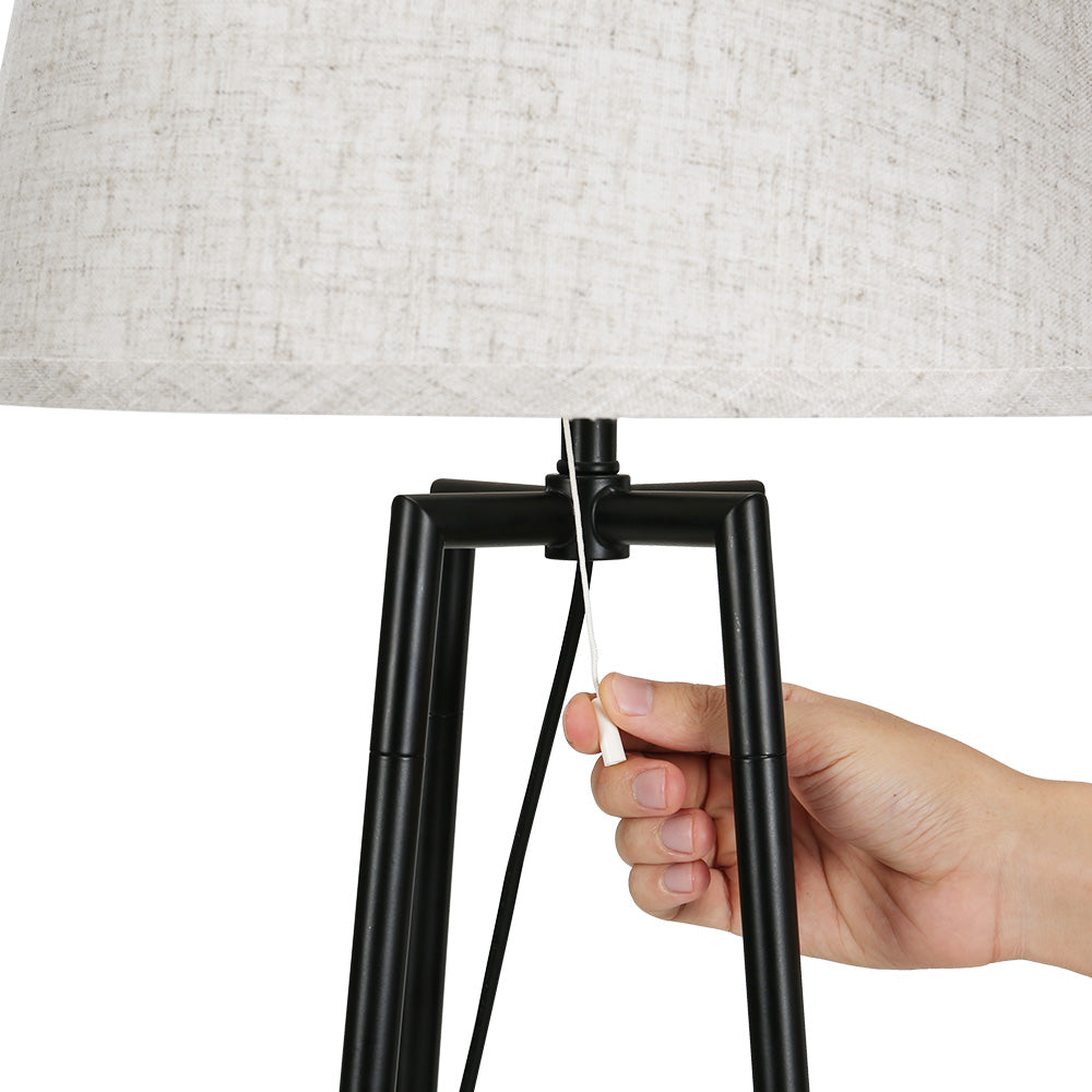 Black floor lamp with storage shelves and linen shade