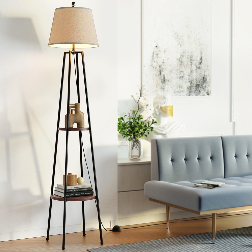 Black floor lamp with storage shelves and linen shade