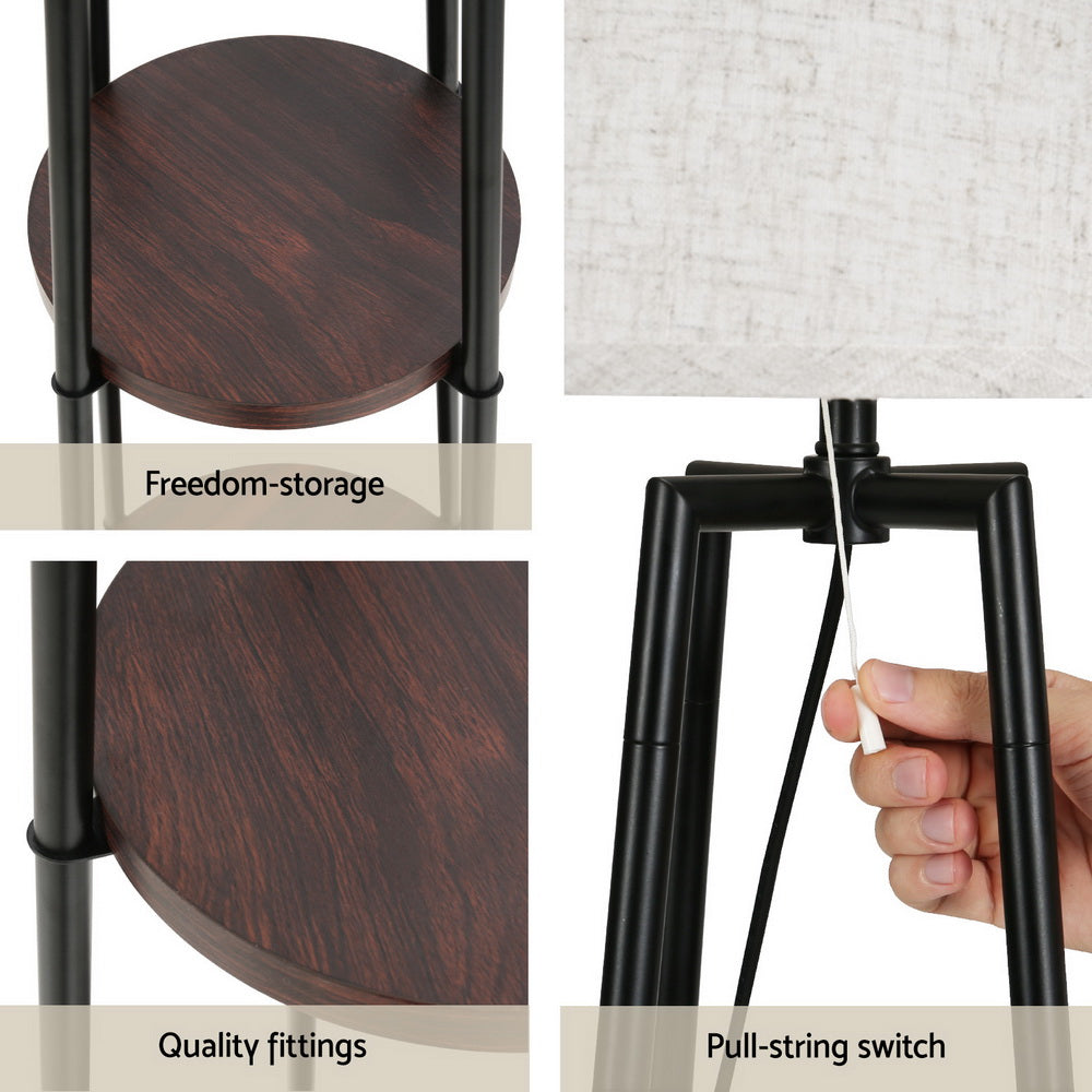 Black floor lamp with storage shelves and linen shade
