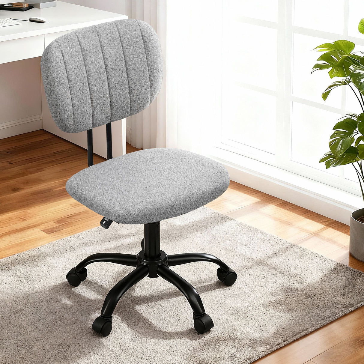 Pingelly grey armless fabric office chair in a small home office