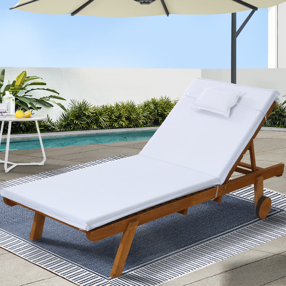 Gerringong natural wood sun lounger with white cushion and wheels on a patio