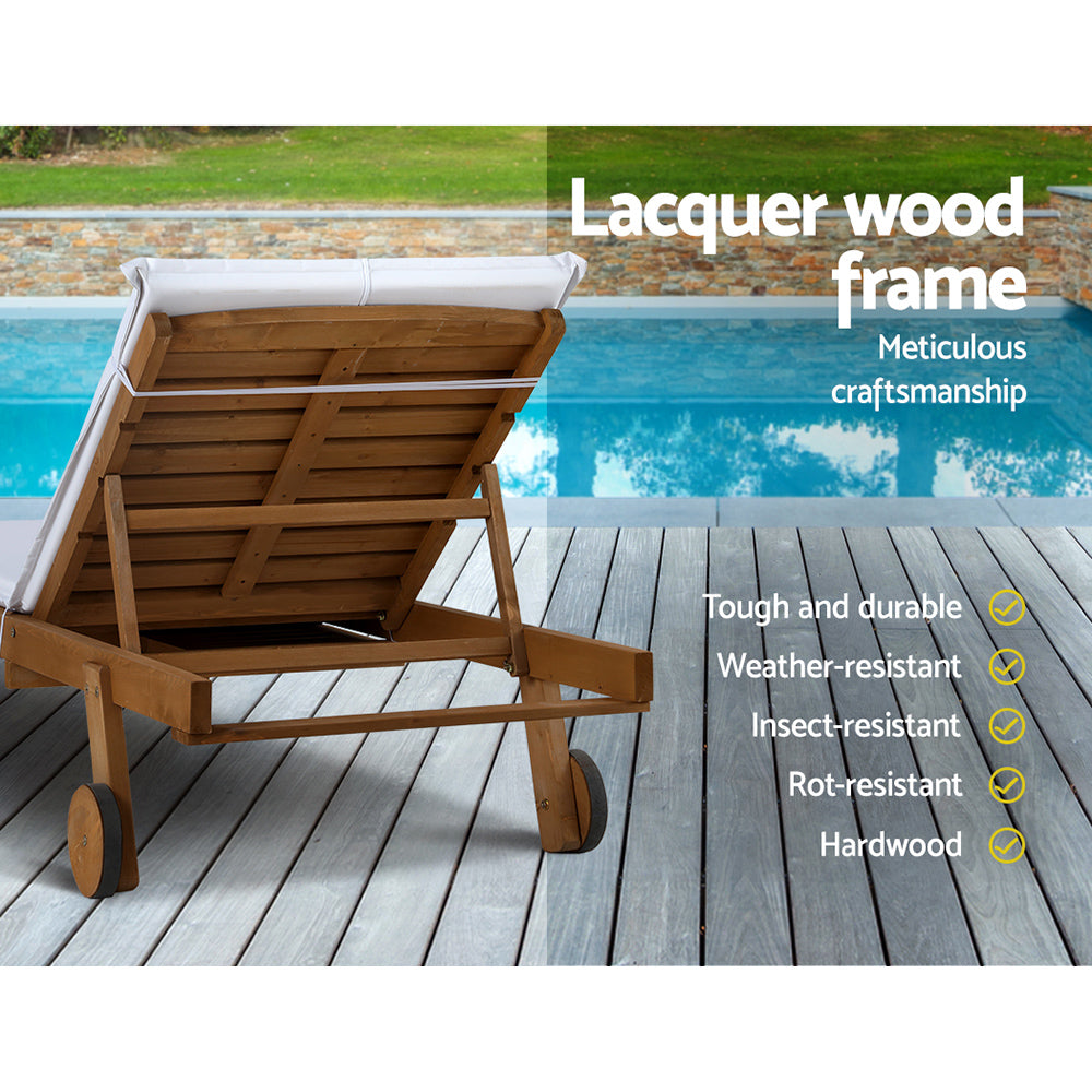 Gerringong natural wood sun lounger with white cushion and wheels on a patio