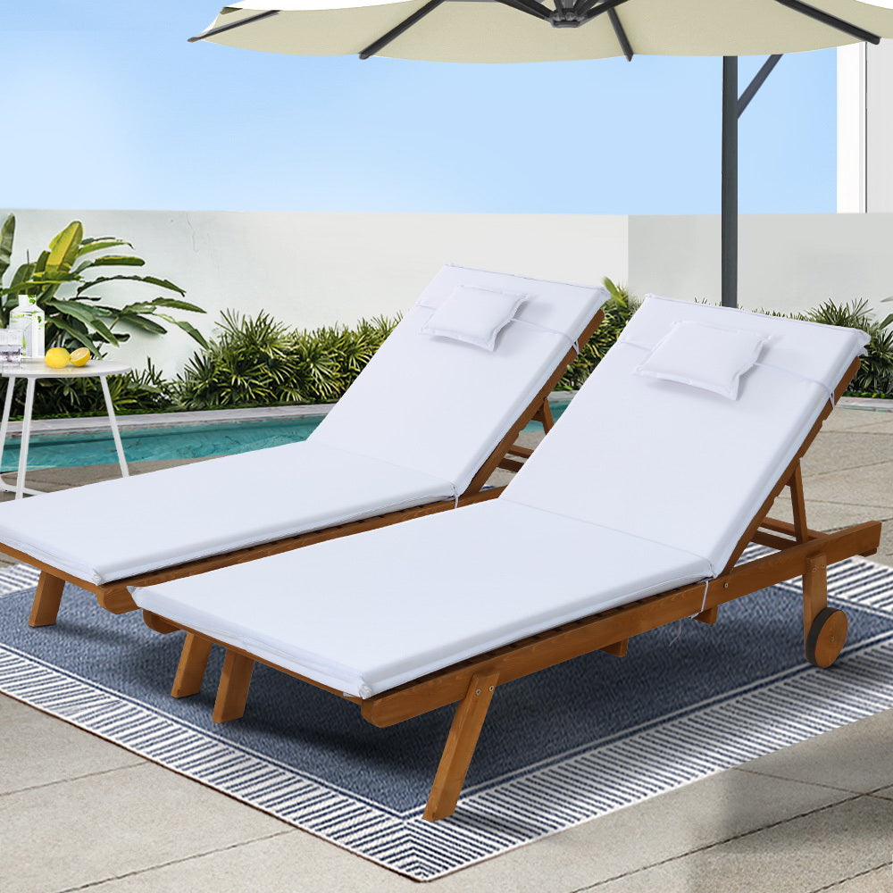 Gerringong natural wood sun lounger with white cushion and wheels on a patio
