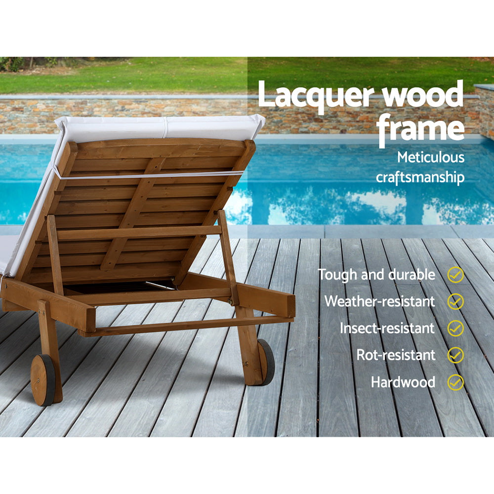 Gerringong natural wood sun lounger with white cushion and wheels on a patio