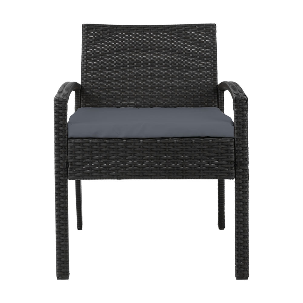 Ulladulla pair of black PE wicker outdoor dining chairs with cushions on a patio