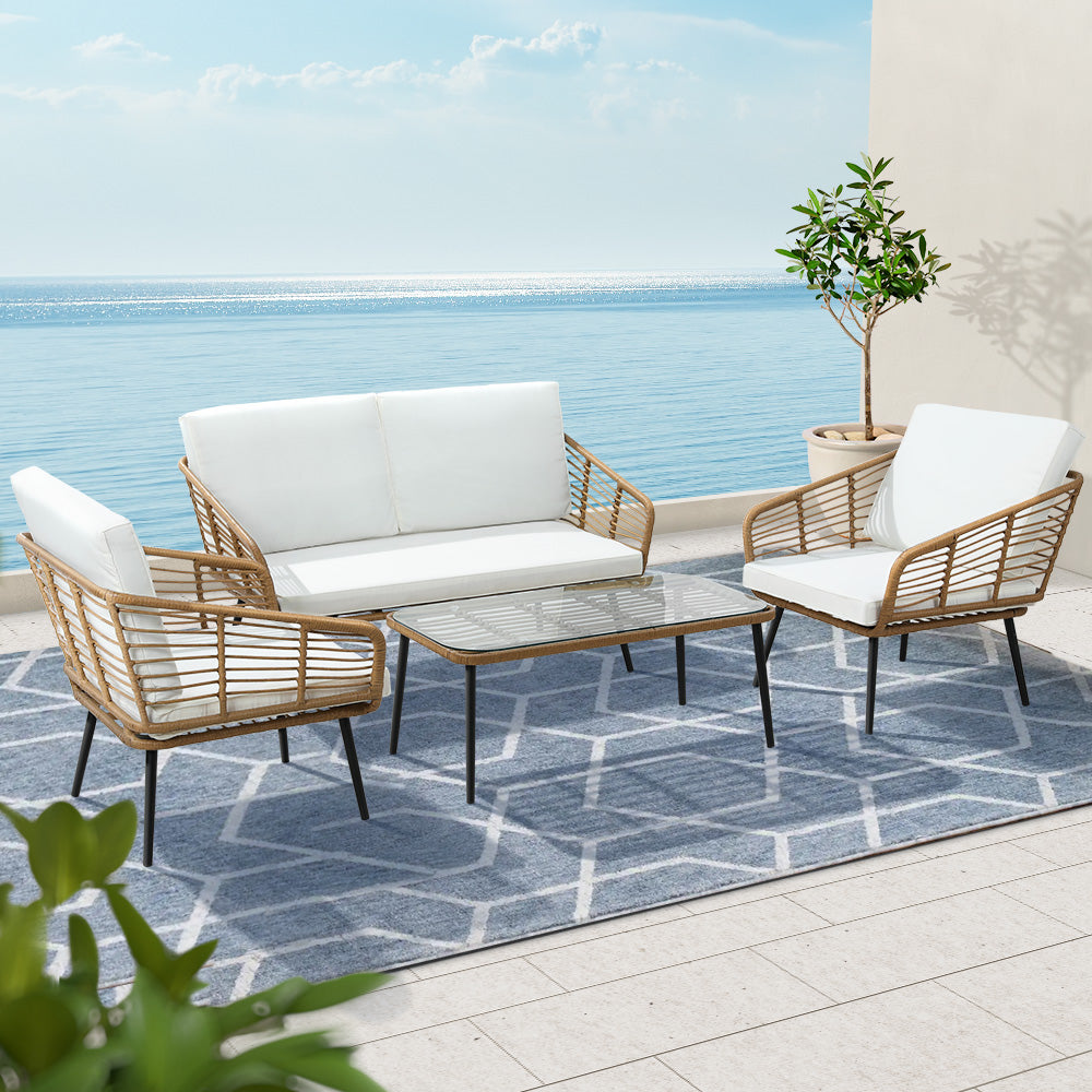 Maudsland natural rattan outdoor lounge set in an outdoor setting