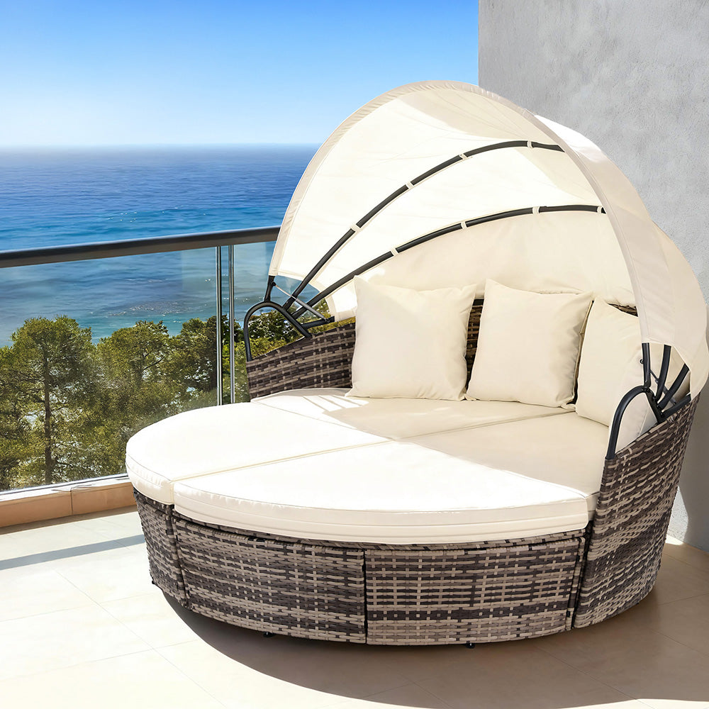 Palm Beach beige wicker outdoor daybed in an outdoor setting