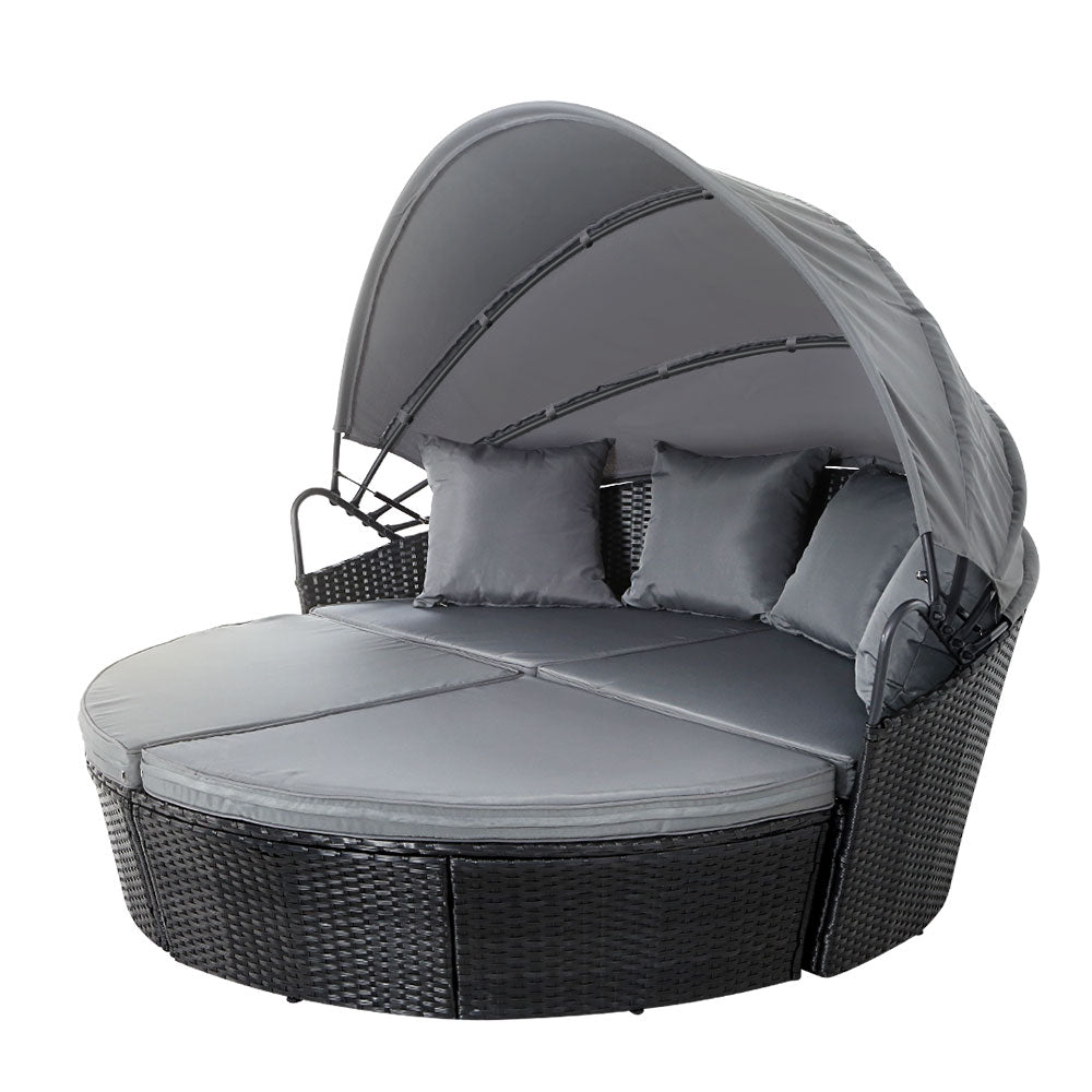 Palm Beach black wicker outdoor daybed in an outdoor setting