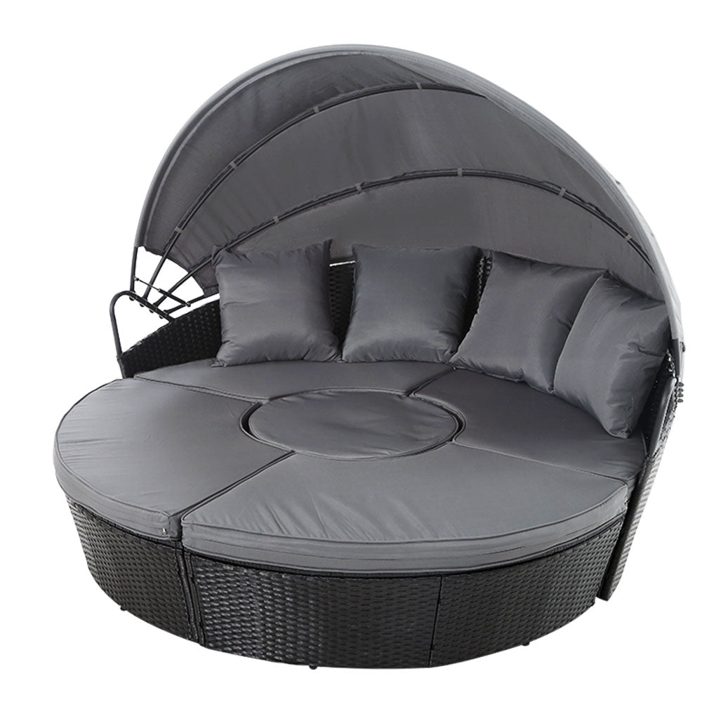 Palm Beach black wicker outdoor daybed in an outdoor setting