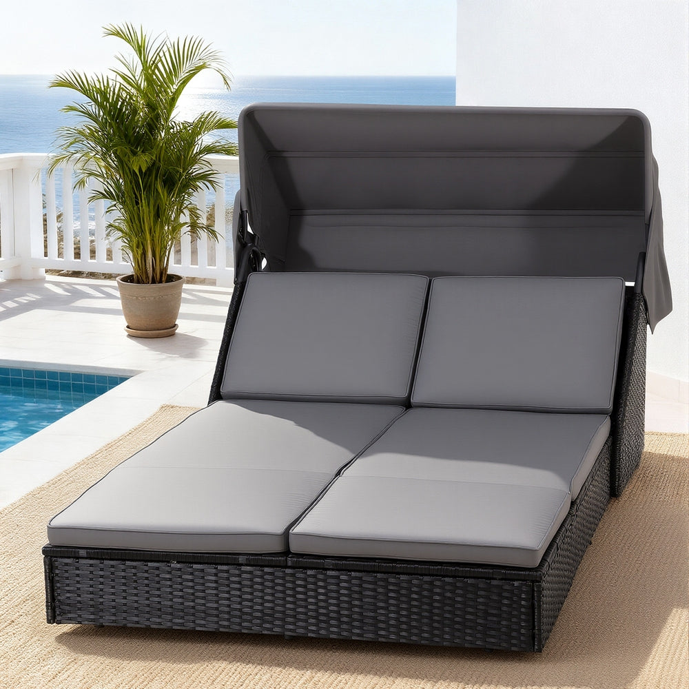 Merimbula outdoor daybed in black PE rattan with adjustable backrest by a pool