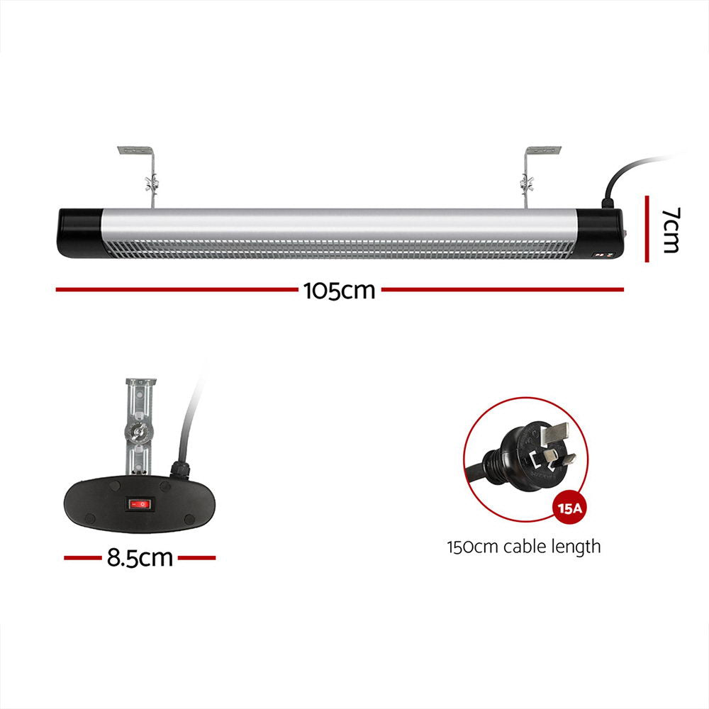 Radiant strip heater mounted on a wall with the carbon fibre elements glowing