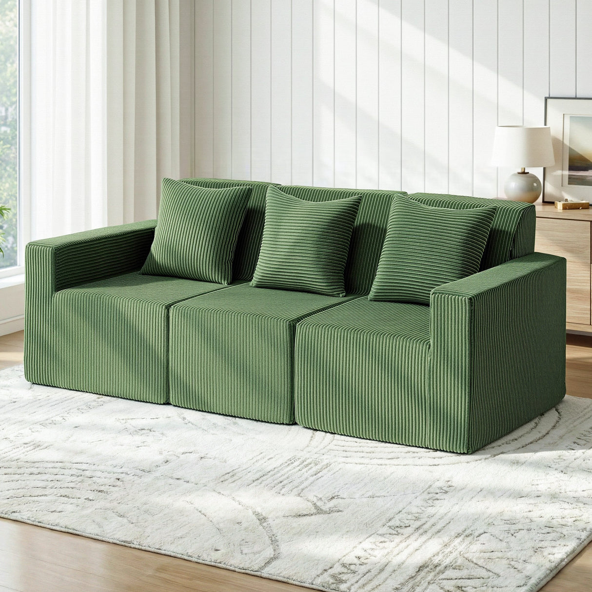 Torredembarra Green corduroy modular sofa in a modern living room