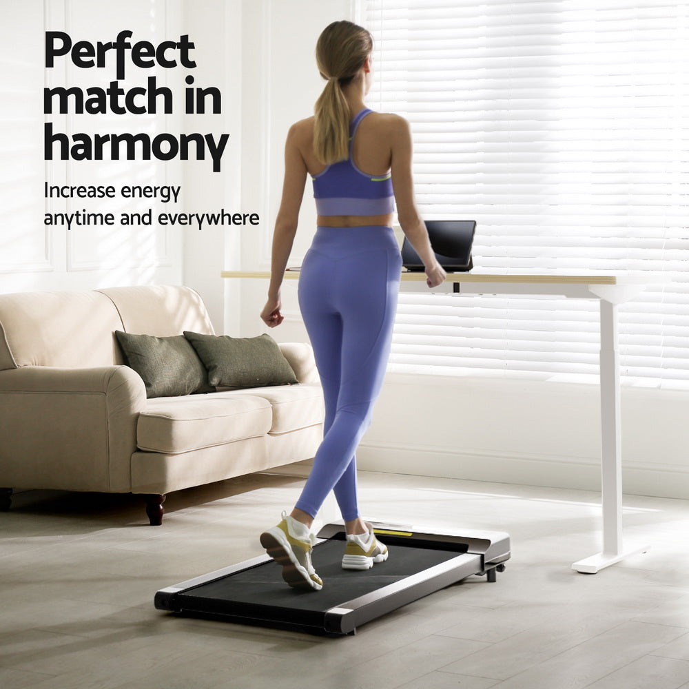 Kingston oak electric standing desk with walking pad in a home office