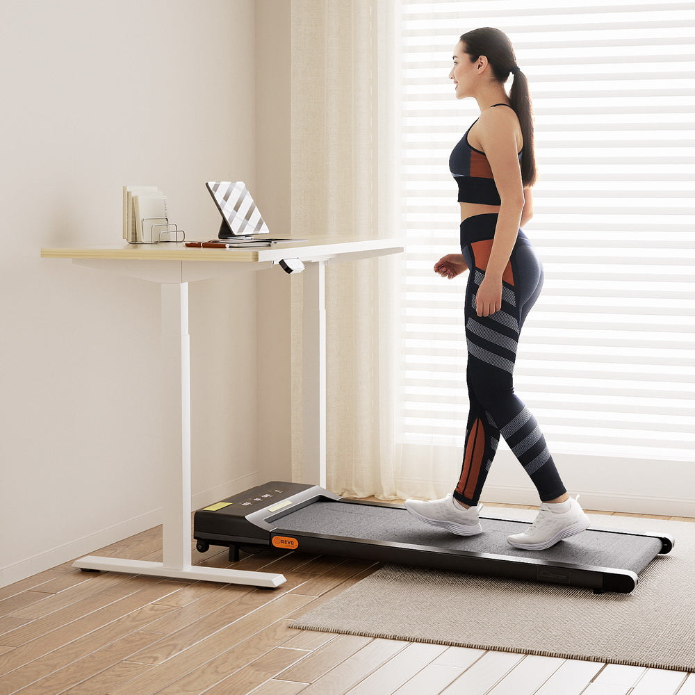 Kingston oak electric standing desk with walking pad in a home office
