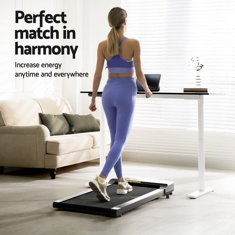 Deakin walnut electric standing desk with walking pad in a home office