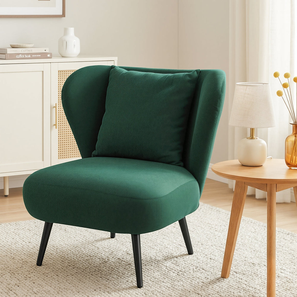 Hartley green corduroy wingback chair in a modern living room