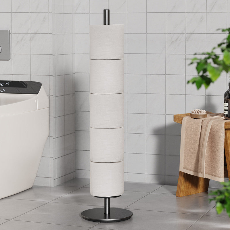 Black iron toilet roll stand holding several spare rolls beside a toilet