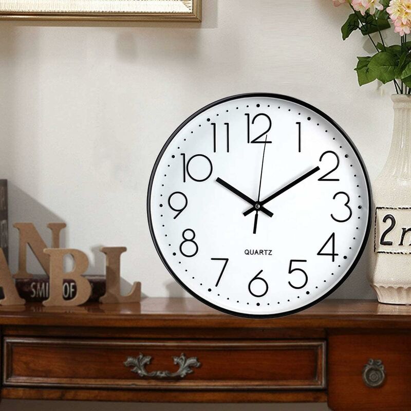 Modern black and white wall clock 12 inch shown on wall