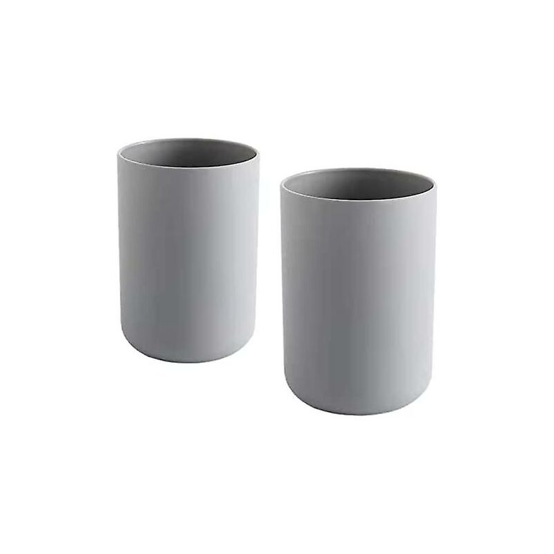 Two grey plastic toothbrush cups standing side by side on a bathroom vanity