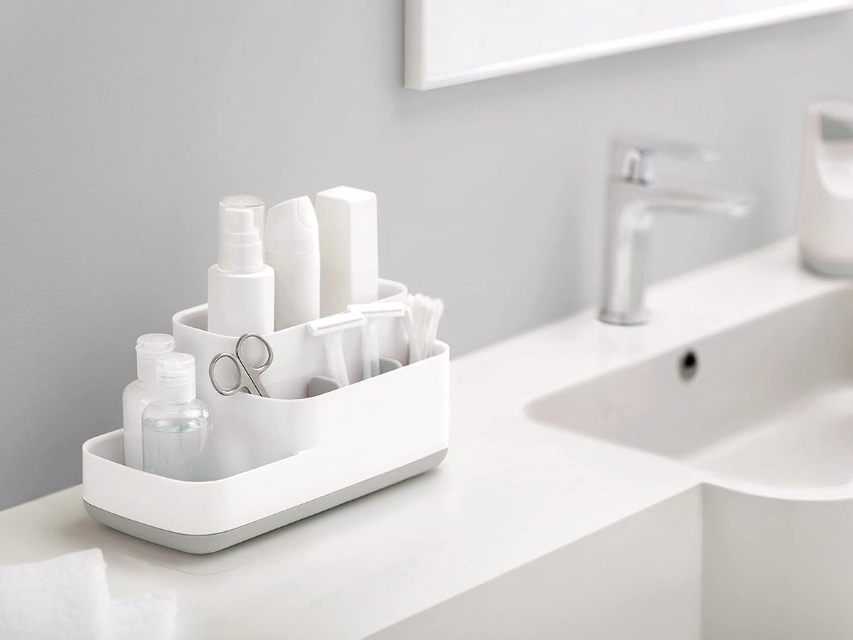 Sorting compartments of the white organiser holding brushes and razors