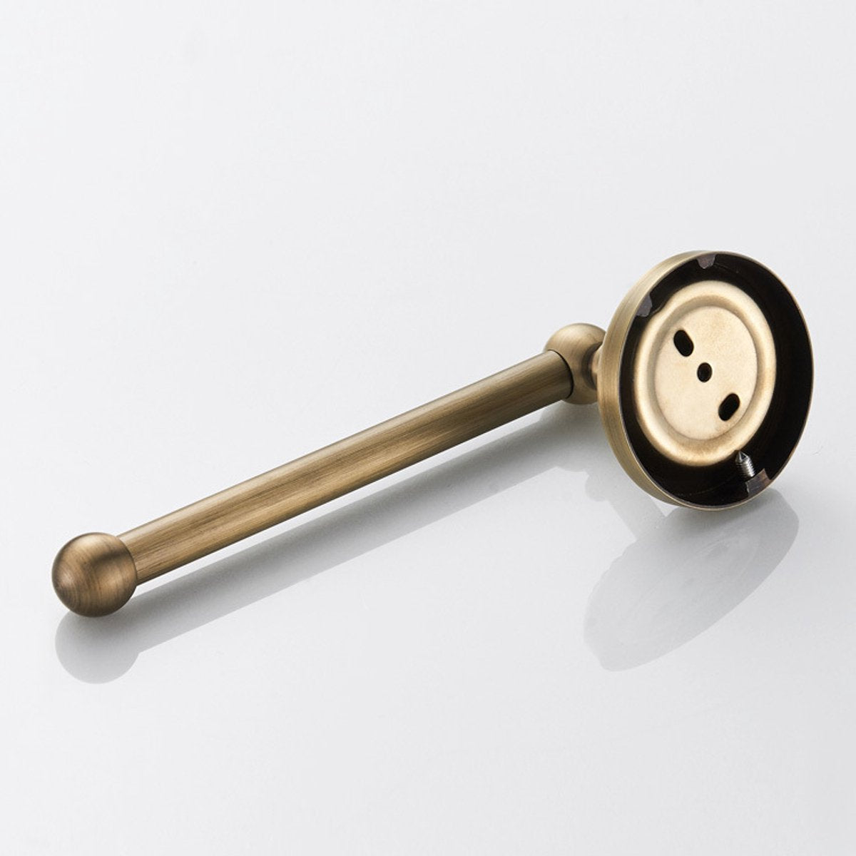 Antique brass toilet roll holder holding an extra large paper roll