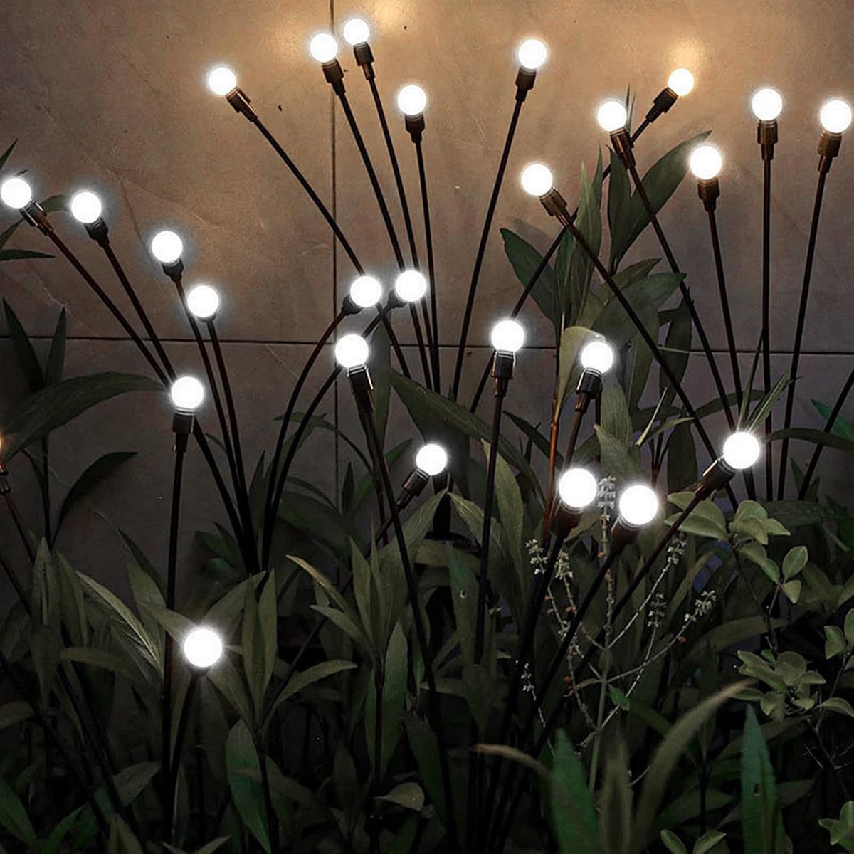 Cool white solar firefly lights swaying among garden planters at night