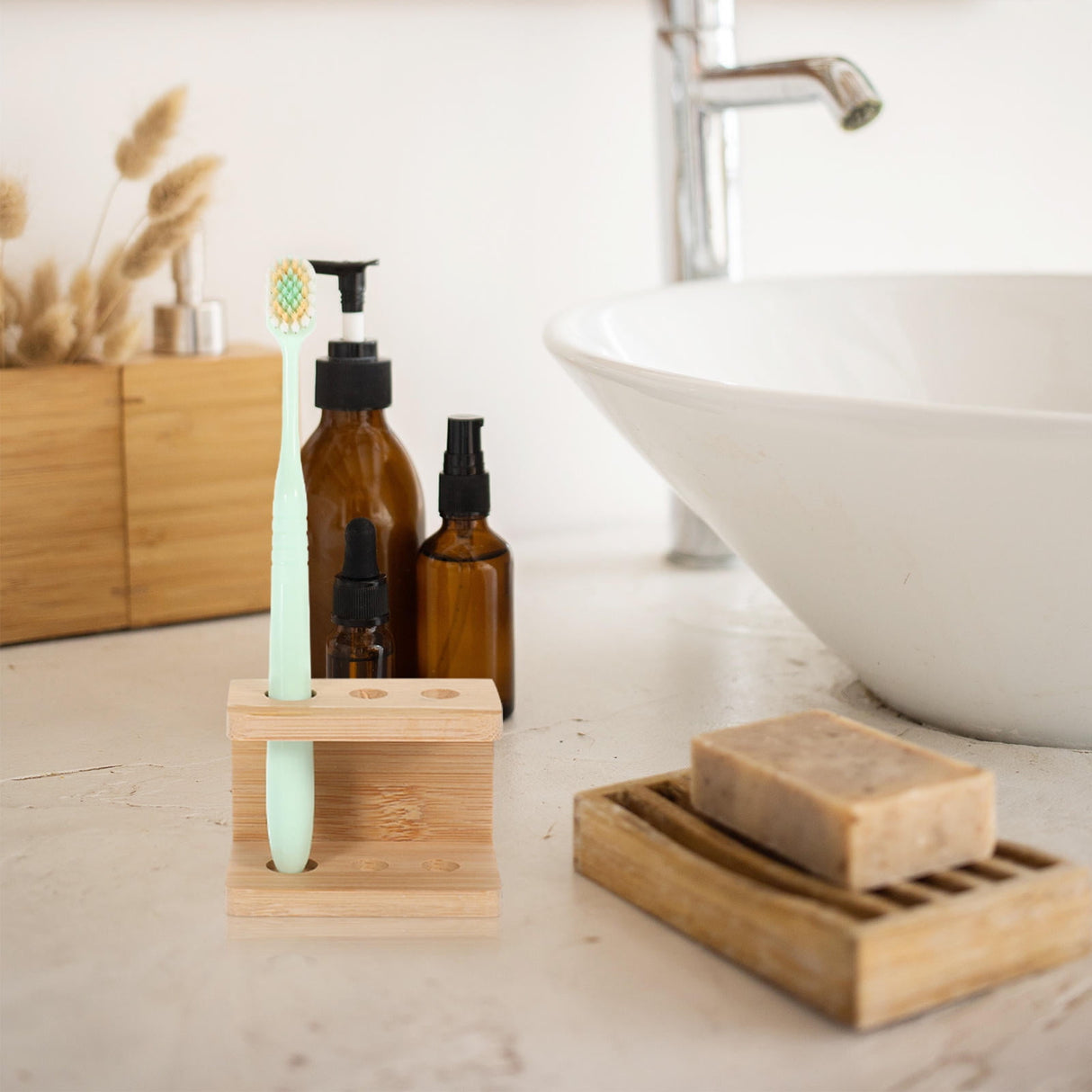 Khaki bamboo toothbrush holder with three compartments on a bathroom counter