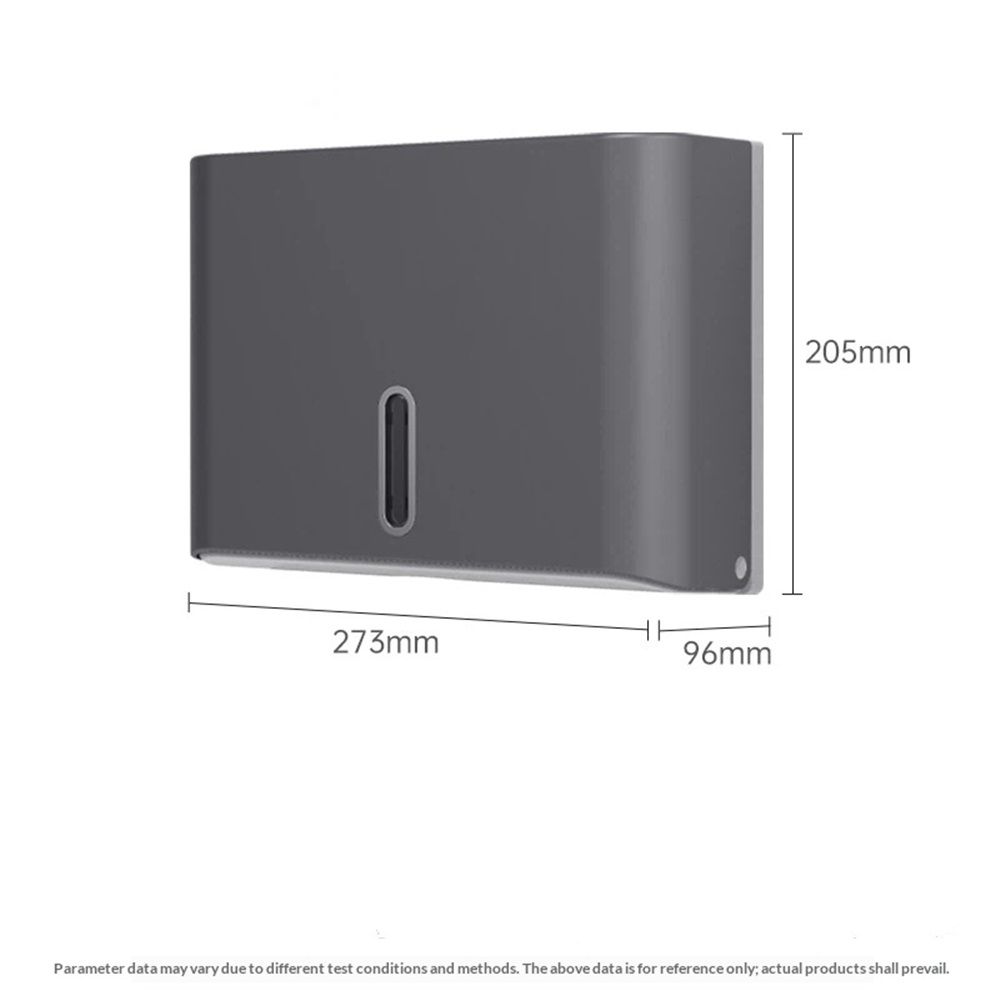 Grey towel dispenser mounted on a tiled washroom wall above a basin