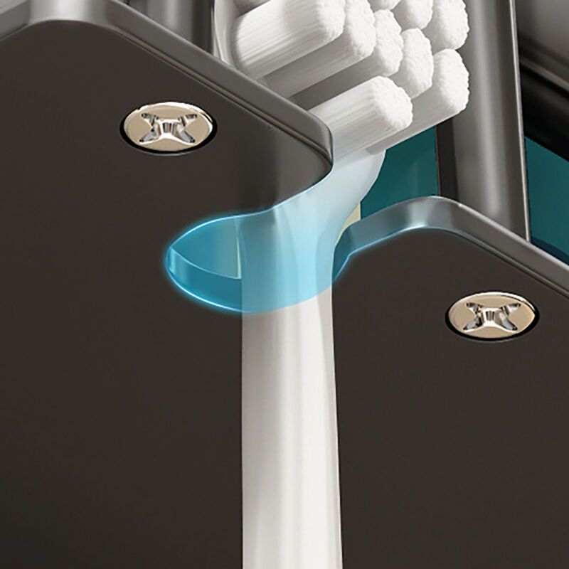 Grey toothbrush holder holding electric toothbrushes and cups on a tiled wall