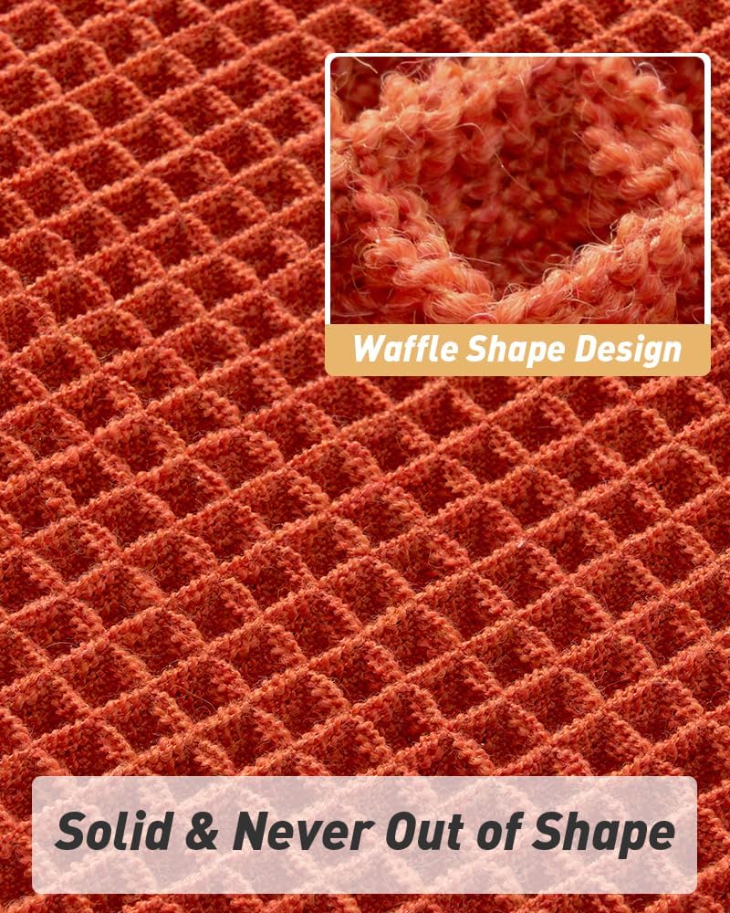 Orange waffle bath mat styled beside a shower in a boho bathroom