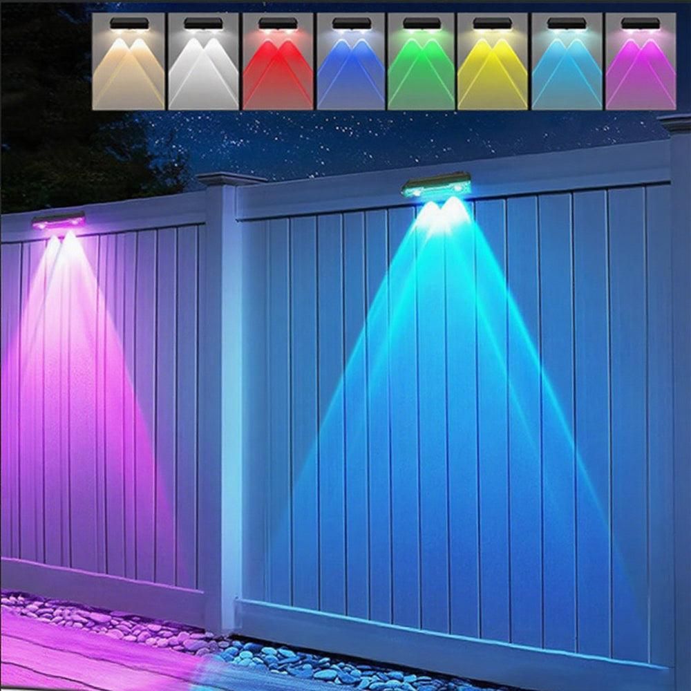 Solar RGB wall washer light casting colour across a garden fence