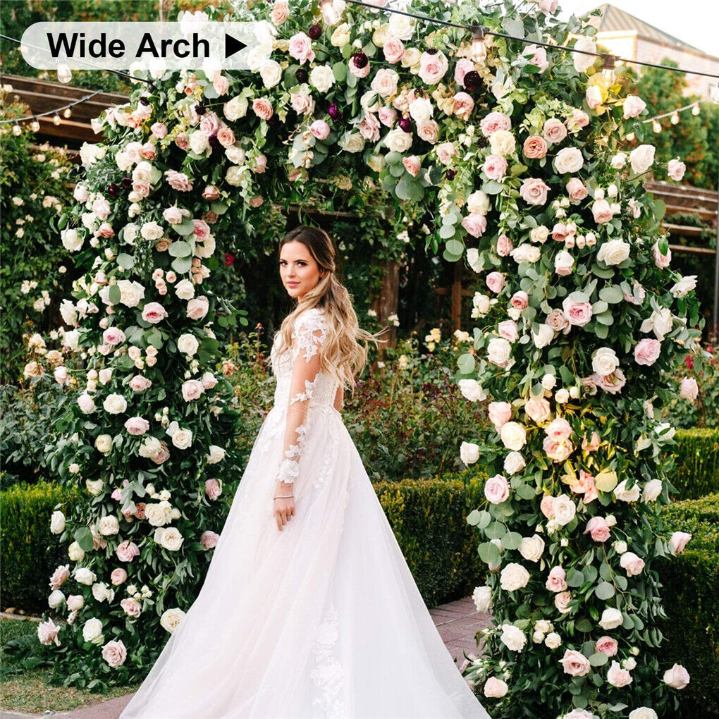 White garden arch used as a wedding ceremony backdrop on open lawn