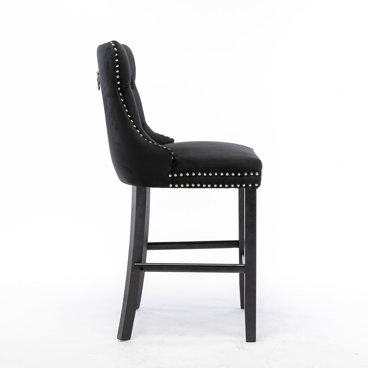 Ranelagh black velvet bar stool with silver stud trim and wooden legs in a dining room