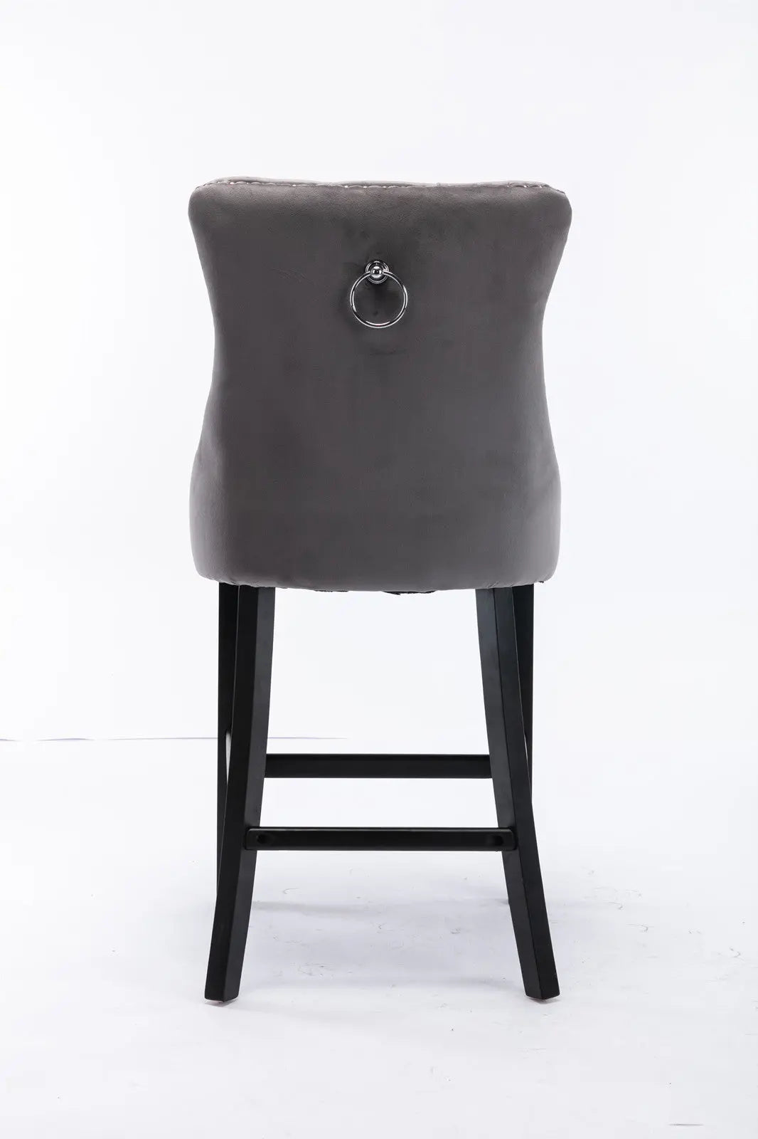 Waterways grey velvet bar stool with silver stud trim and wooden legs in a dining room