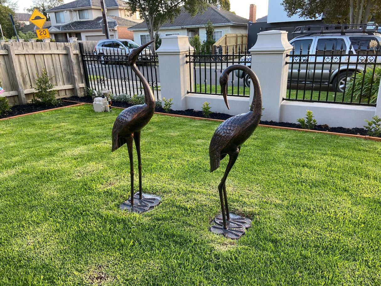 Two piece cast aluminium garden crane statue set in dark bronze