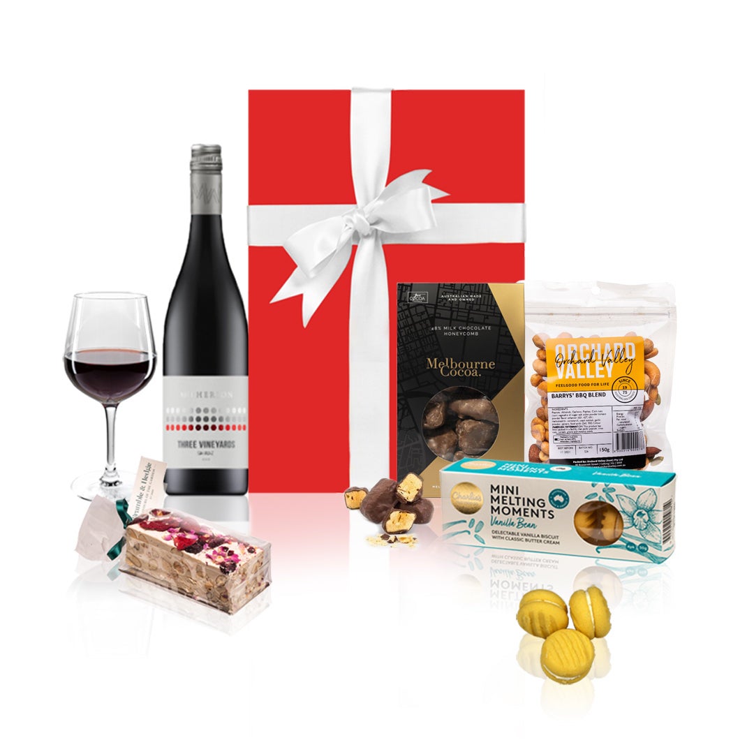 Red Wine and Gourmet Sweets Gift Hamper in a red box with a white bow