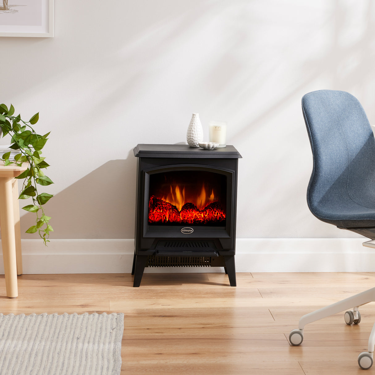 Black portable electric stove styled on a hearth in a living room