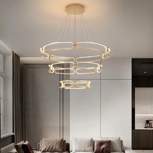 Gold three ring chandelier illuminated in a living room