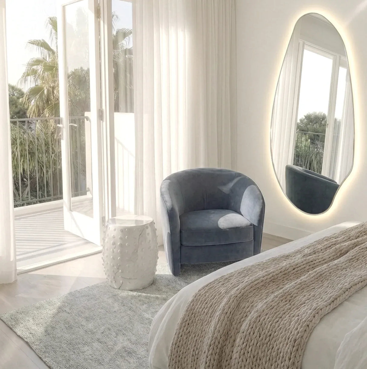 Aireys irregular backlit LED wall mirror in a contemporary dressing room