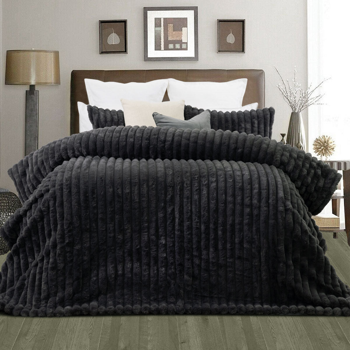 Channel stitched charcoal faux fur comforter set with two pillowcases on a king bed