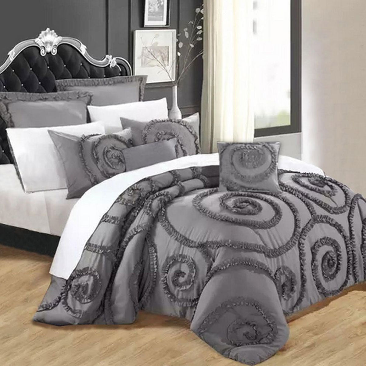 Charcoal seven piece comforter set with a floral print and ruffled edging on a queen bed