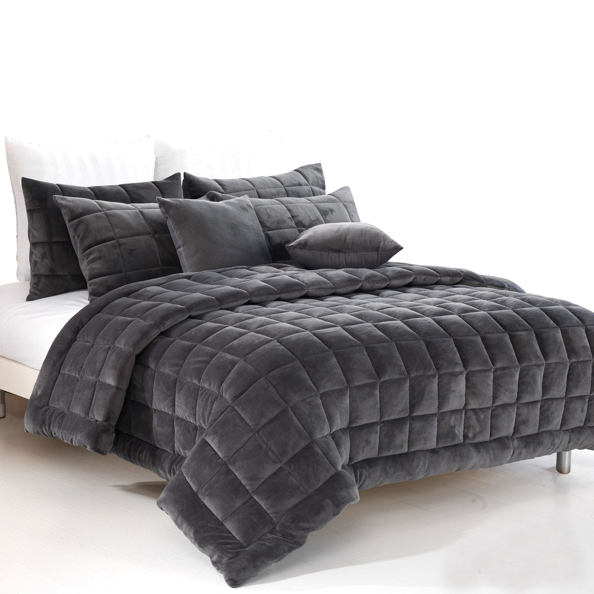 Charcoal faux mink quilt with quilted squares and two pillowcases on a Queen bed