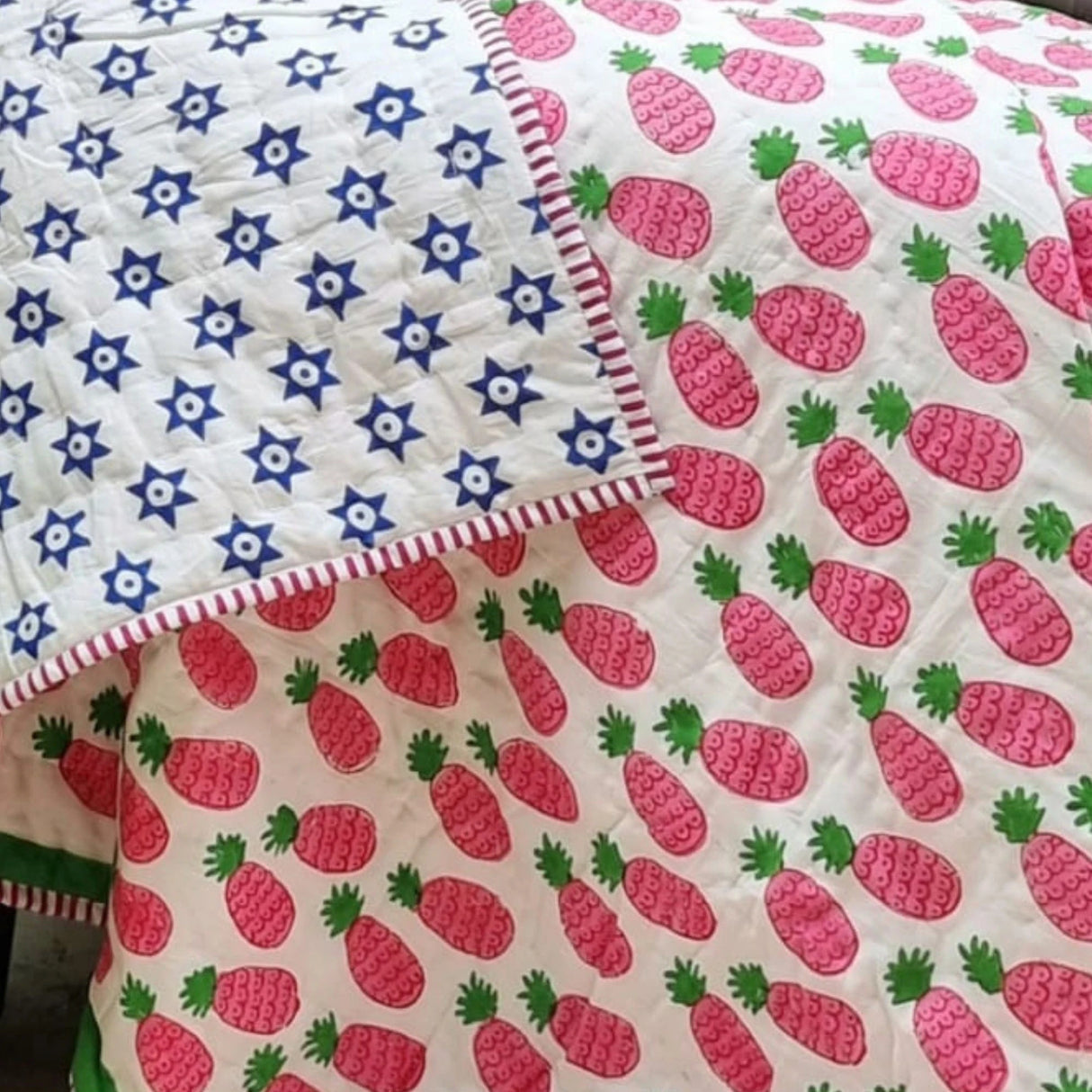 Organic cotton reversible baby quilt in pink pineapple print