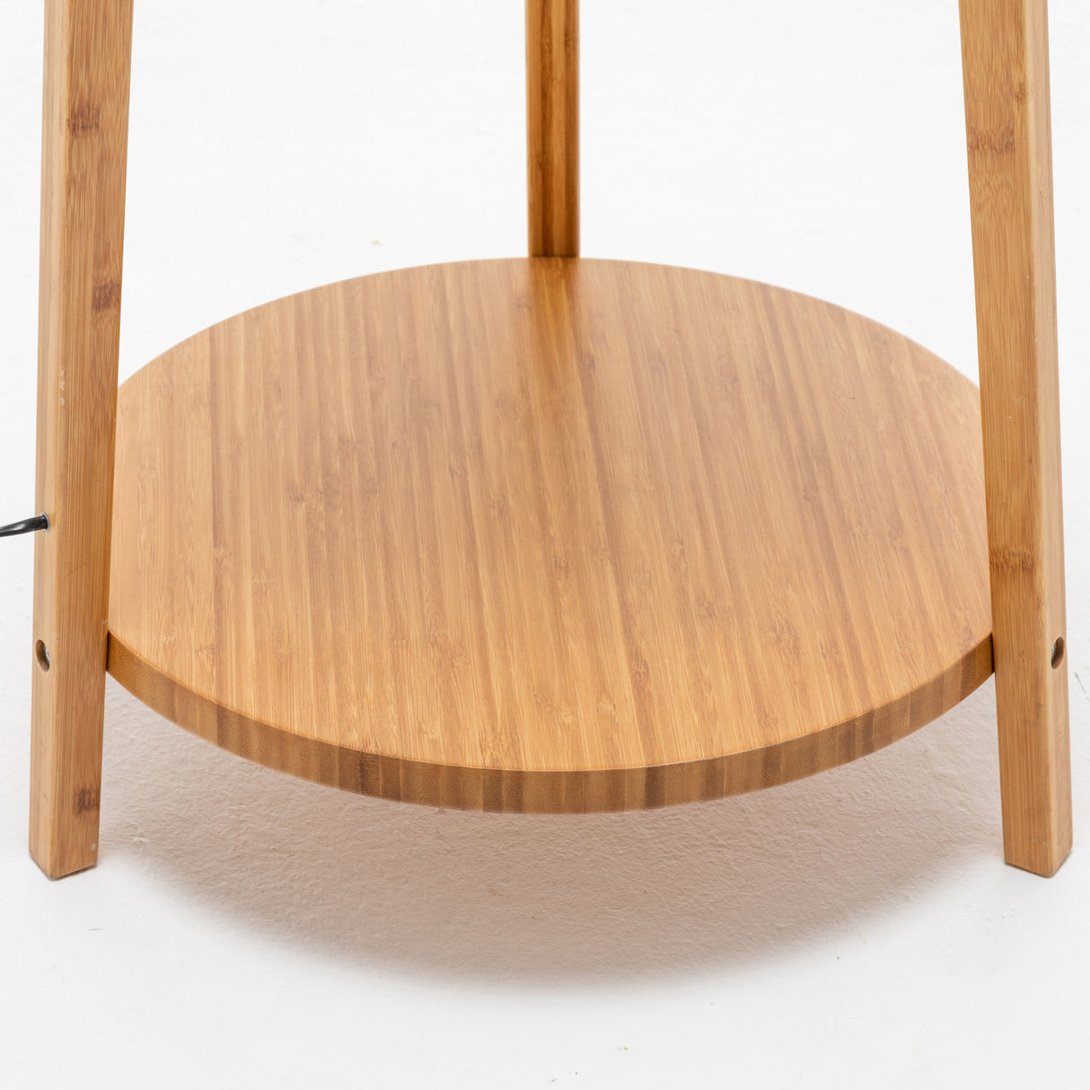 Bamboo tripod floor lamp with linen shade and storage shelves