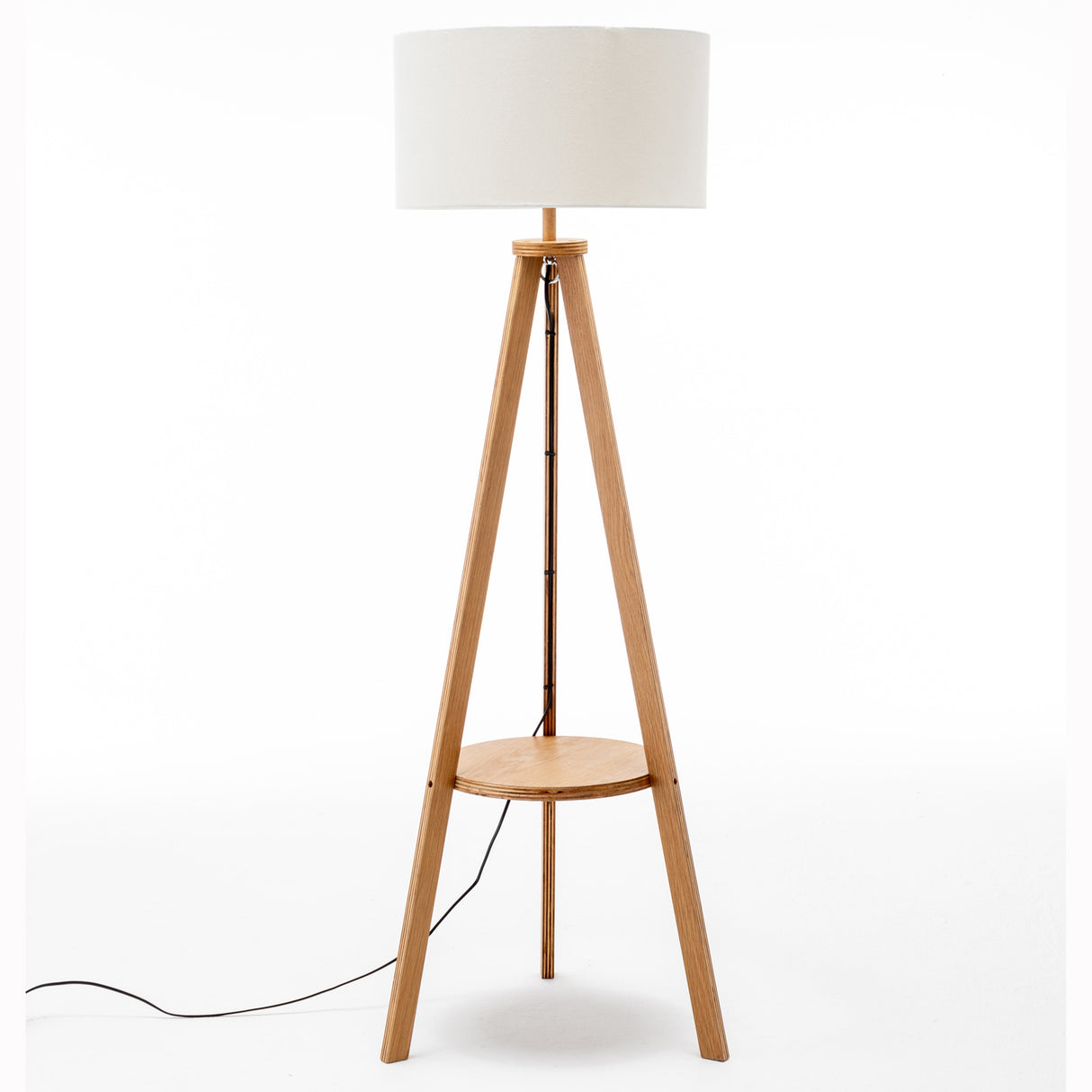 Natural wooden tripod floor lamp with round shelf and off white linen shade