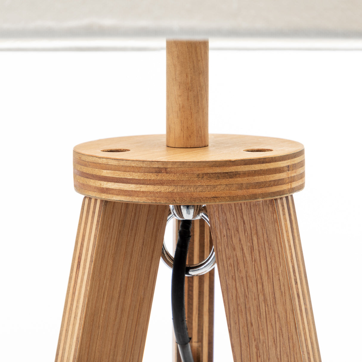 Natural wooden tripod floor lamp with round shelf and off white linen shade