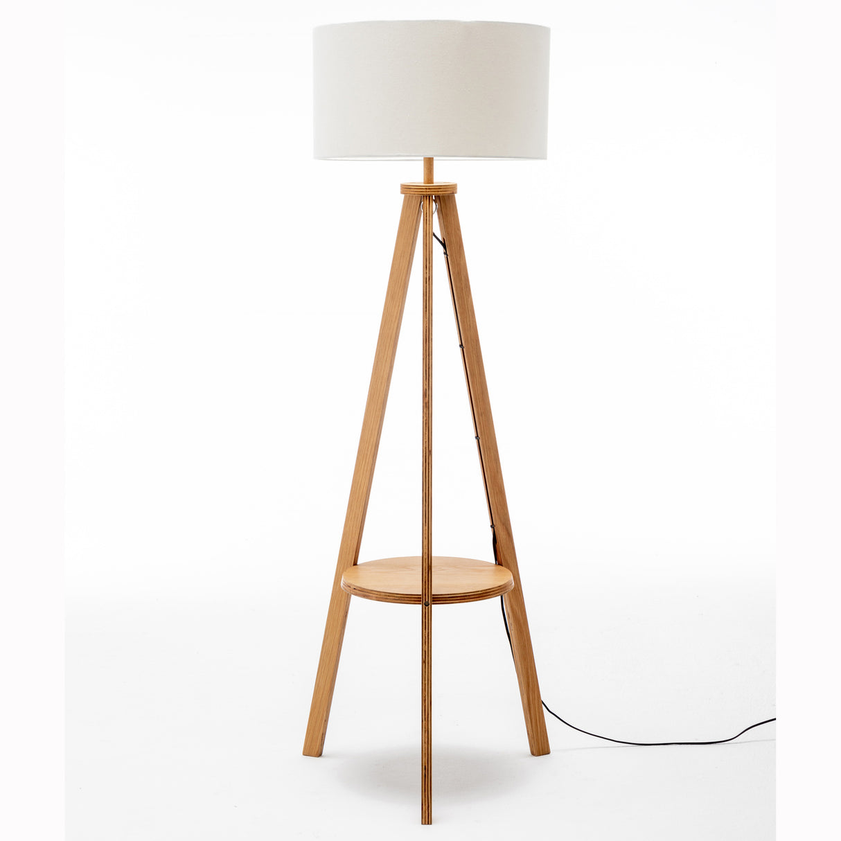 Natural wooden tripod floor lamp with round shelf and off white linen shade
