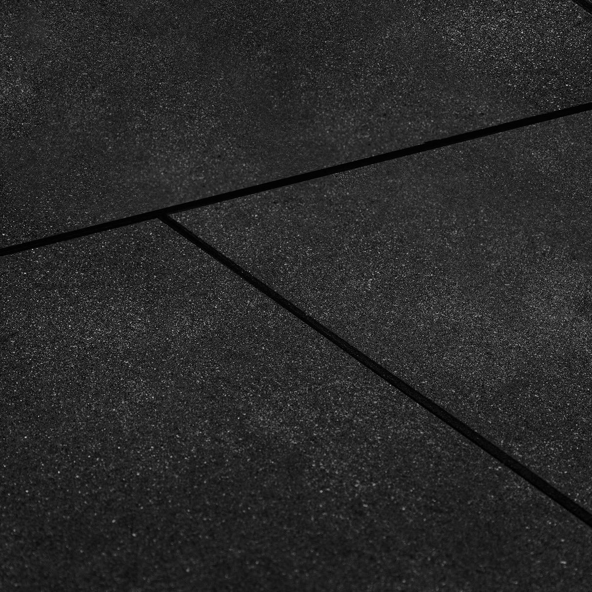 Large coverage of black bevelled edge rubber gym floor tiles in a commercial gym