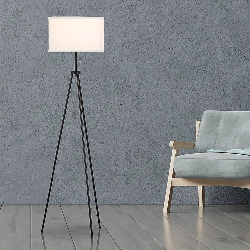 Mid century tripod floor lamp with ivory drum shade and black legs